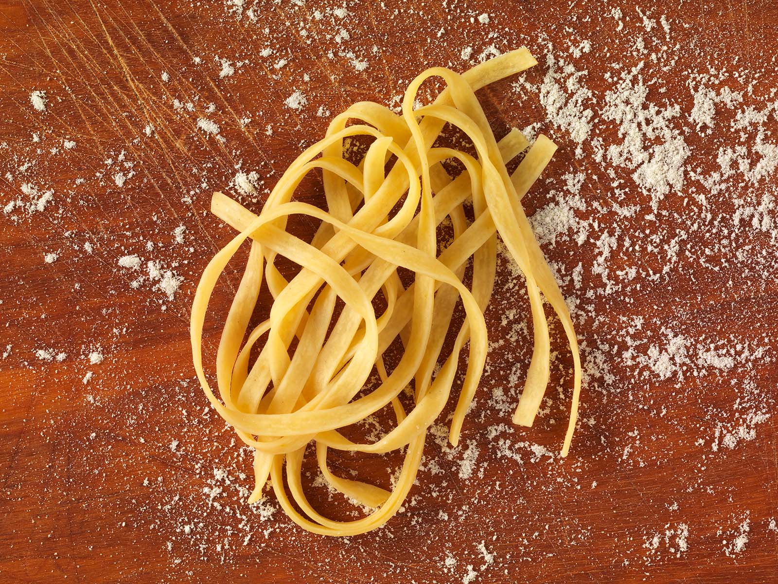 Fettucine mit Ei auf Brett angerichtet